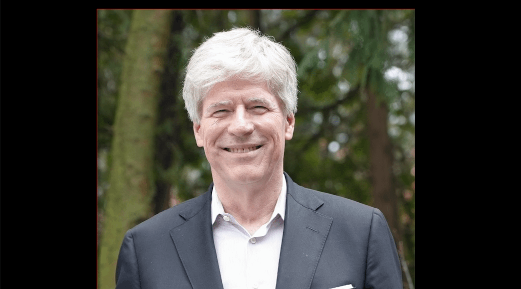 A smiling white haired man
